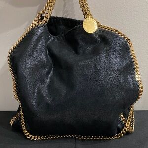 Like new, Stella McCartney black bag with gold hardware.